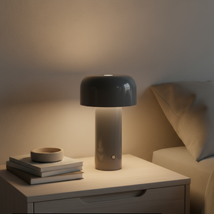 Dark gray lamp on a bedside table with books