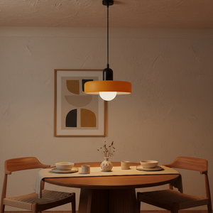 Dining area with a round table, chairs, and a pendant light fixture.