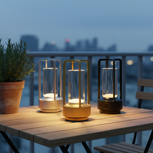 Three outdoor lanterns on a wooden table with a cityscape in the background
