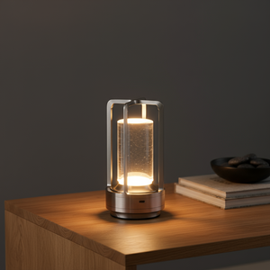 Modern table lamp with a glass shade on a wooden surface against a dark background