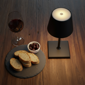 black table lamp on a wooden table with a glass redwine