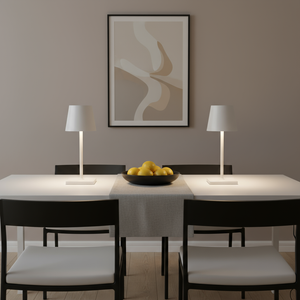 Dining room with a table, chairs, and a bowl of fruit on a neutral background