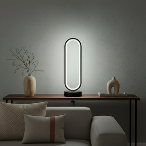 Modern table lamp on a wooden side table with decorative vases and a sofa in the background.