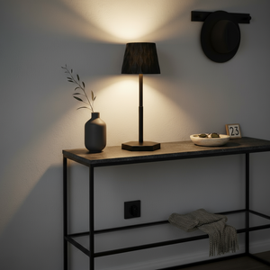 Black lamp on a black shelf and minimalistic decoration