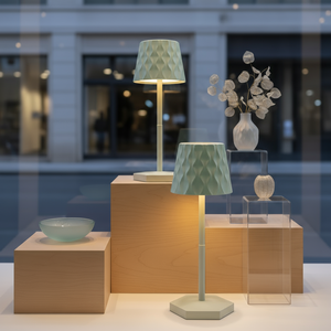 Decorative lamps and vases on wooden and glass stands with a blurred indoor background.