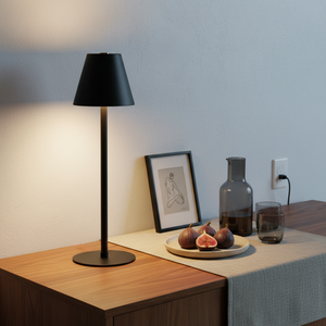 Two black lamps on either side of a window with blue tiles, showing a bowl of fruit and bottles.