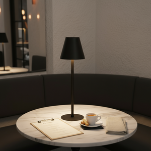 Black table lamp on a wooden surface with a neutral background