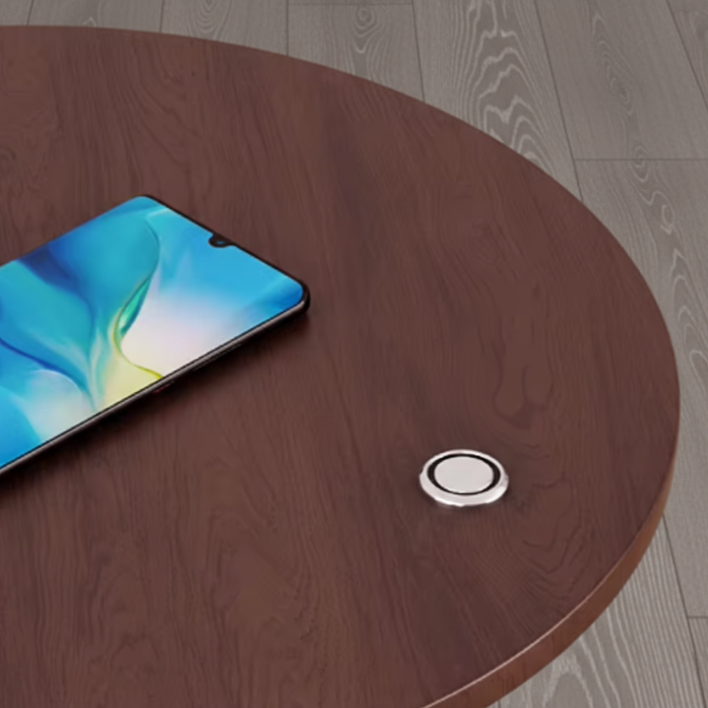 Smartphone on a wooden table with a wireless charging pad