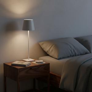 Napoleon Chao table lamp on a bedside table next to a bed with pillows.
