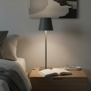 Modern bedroom with a lamp, book, and glasses on a nightstand.