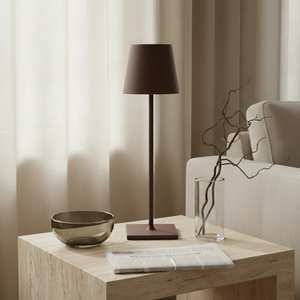 Modern living room with a wooden side table featuring a lamp, bowl, and vase.