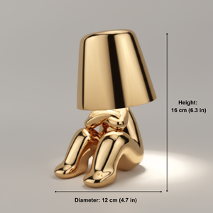 Gold-colored lamp with dimensions indicated on a gray background