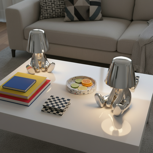 Modern living room with a coffee table featuring decorative items and a couch in the background.