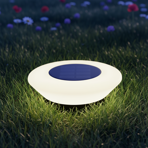 Glowing solar-powered garden light on grass with flowers in the background