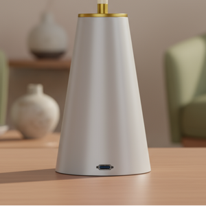 White and gold vase on a wooden table with a blurred living room background