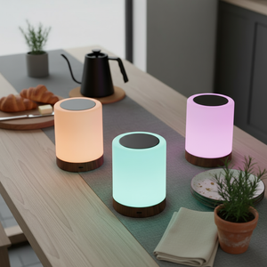 Three colorful cylindrical lamps on a kitchen counter with a blurred background