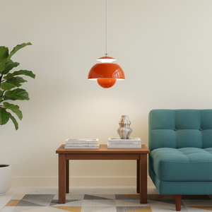 Living room with a teal sofa, wooden table, and orange pendant lamp.