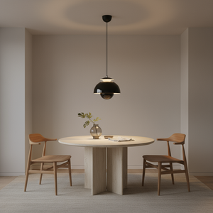Dining room with a round table and wooden chairs, featuring a black pendant light.