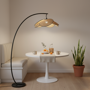 Modern floor lamp with a unique design in a cozy room with a table and plant.