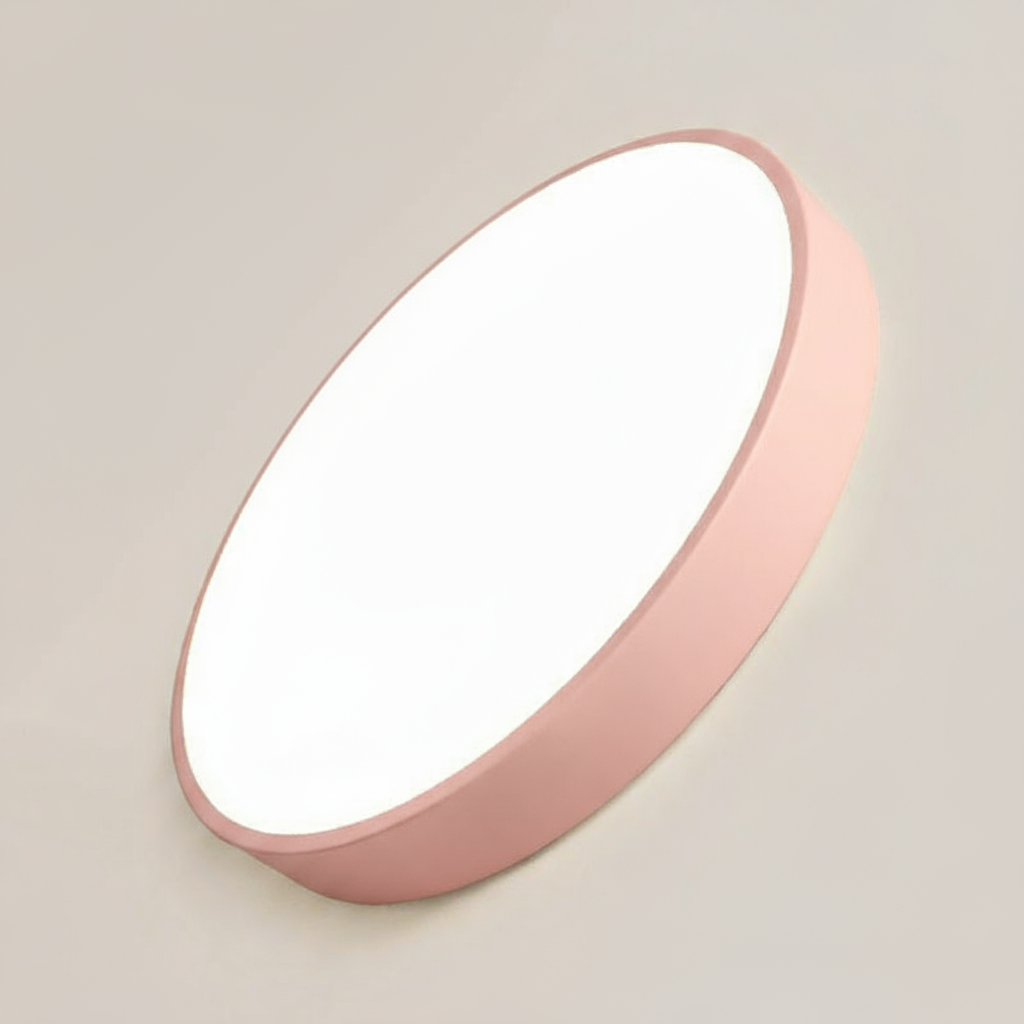 Round pink light fixture on a beige wall