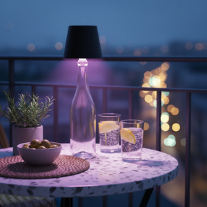 Table setting with drinks and snacks on a balcony at night