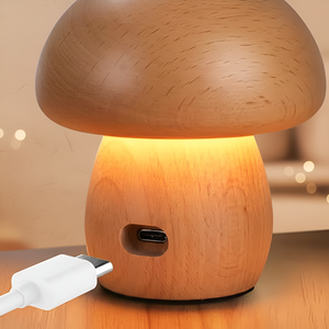 Wooden mushroom-shaped lamp with USB cable on a wooden surface