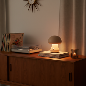 Mushroom-shaped lamp on a wooden surface with a record player and books in a cozy room.