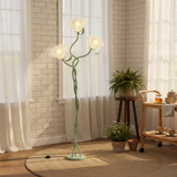 Decorative floor lamp in a room with plants and a small table.