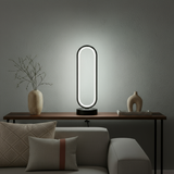 Modern table lamp on a wooden side table with decorative vases and a sofa in the background.